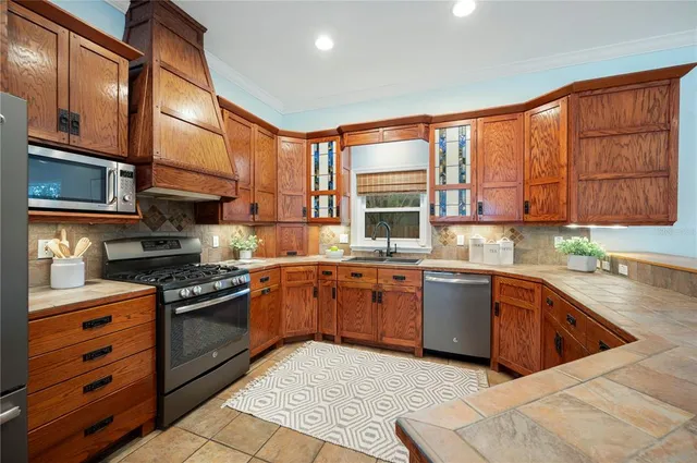a kitchen with stainless steel appliances granite countertop a stove and a sink