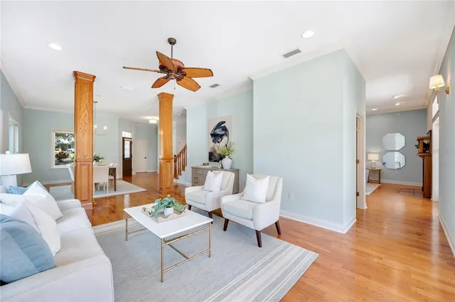 a living room with furniture and a wooden floor