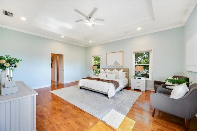 a bedroom with a bed and wooden floor