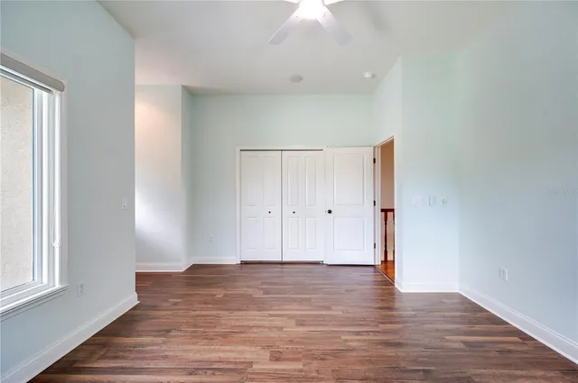 a view of a patio with a table chairs and a floor to ceiling window