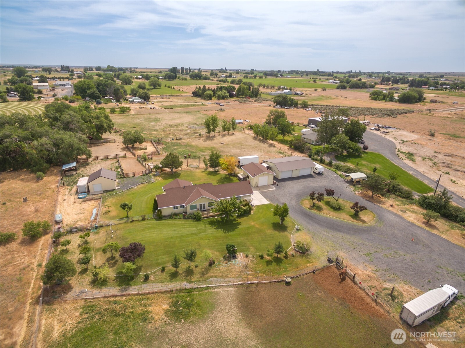 an aerial view of ocean and residential houses with outdoor space