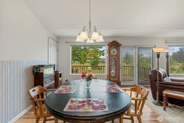 a dining room with a table or chairs and a dining table with garden view