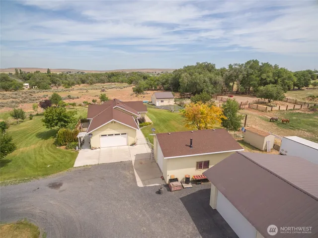 aerial view of a house with outdoor space and lake view in back