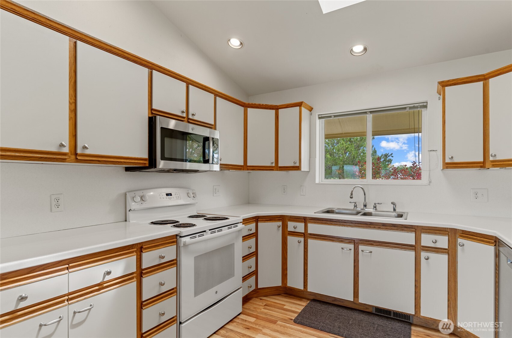 19627 Rd A Northeast Soap Lake, WA 98851 - Photo 22 of 38 a kitchen with granite countertop a sink cabinets stainless steel appliances and a window
