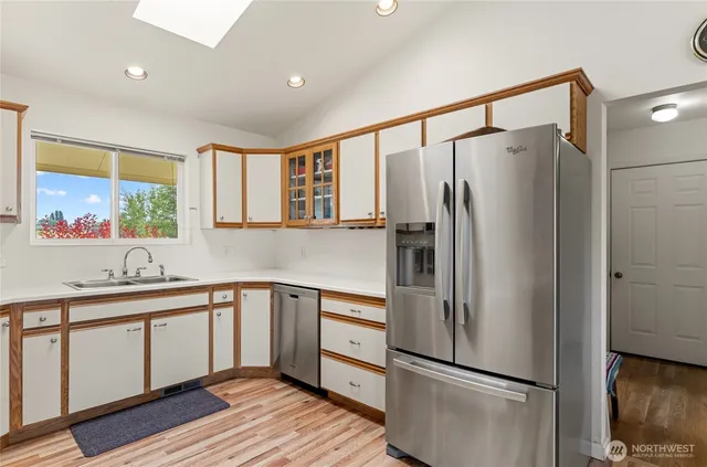 a kitchen with a refrigerator and a sink