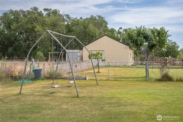 a view of a swimming pool with a house in the background
