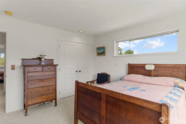 a bedroom with a bed and a dresser