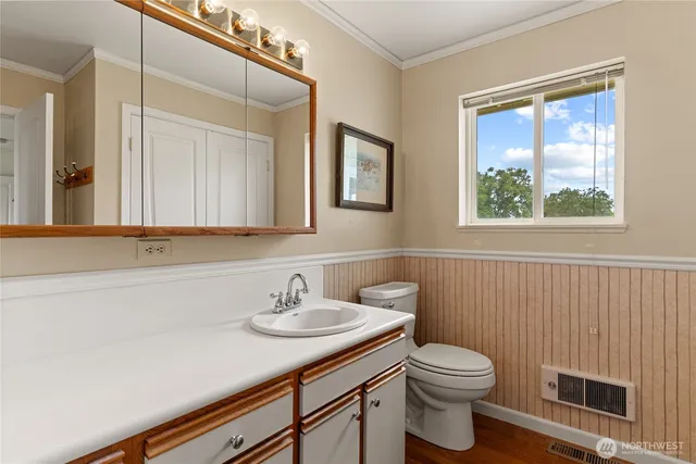 a bathroom with a sink a toilet and mirror