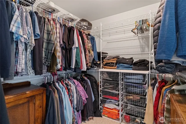 a view of walk in closet with clothes
