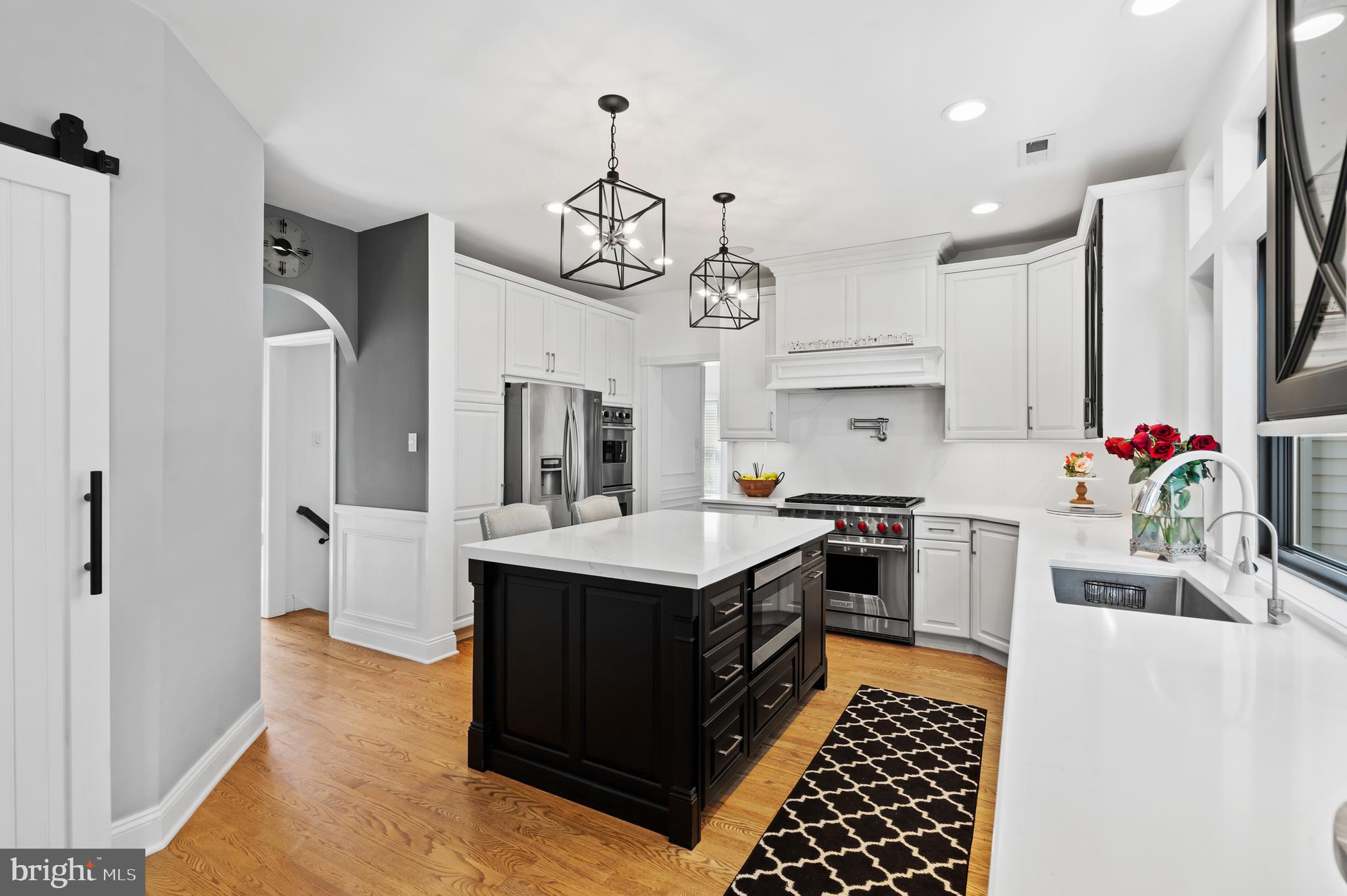 75 Bittersweet Drive Doylestown, PA 18901 - Photo 16 of 65 a kitchen with stainless steel appliances a stove a sink dishwasher and white cabinets with wooden floor