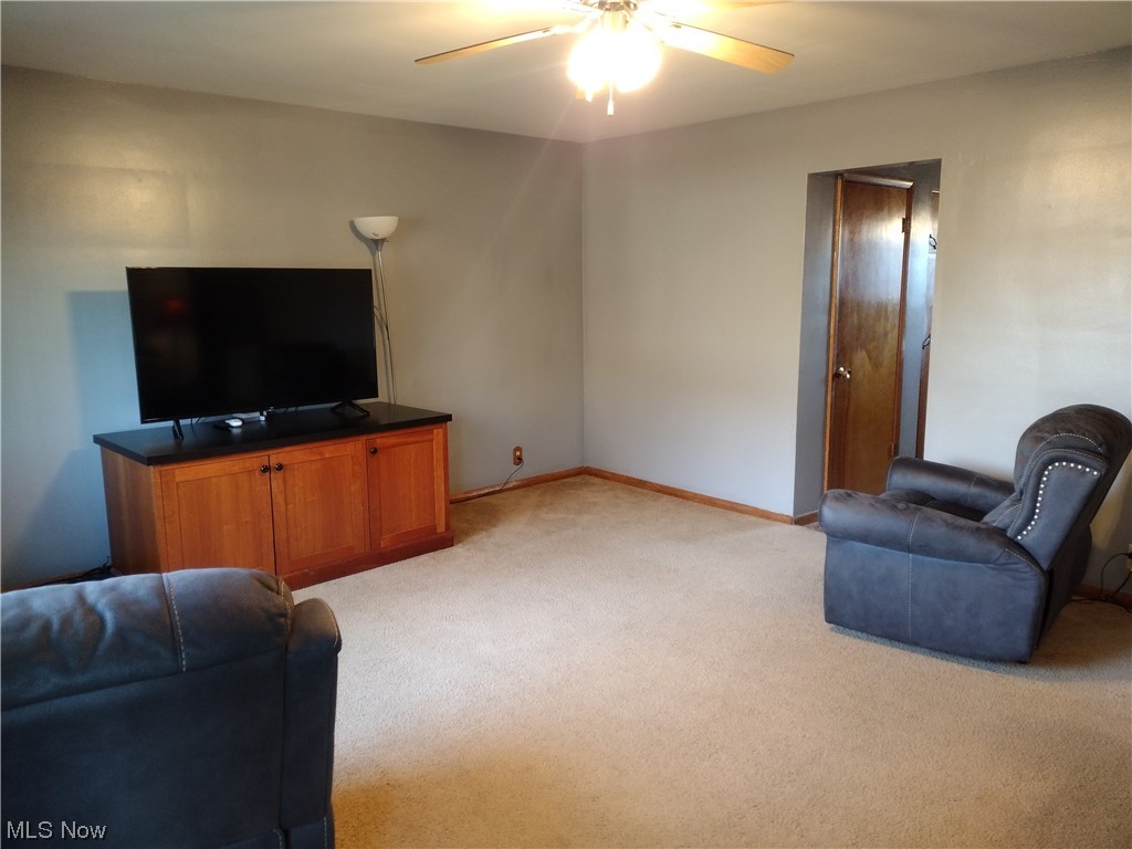 40 Taylor Road Barberton, OH 44203 - Photo 2 of 18 Living room with light colored carpet and ceiling fan