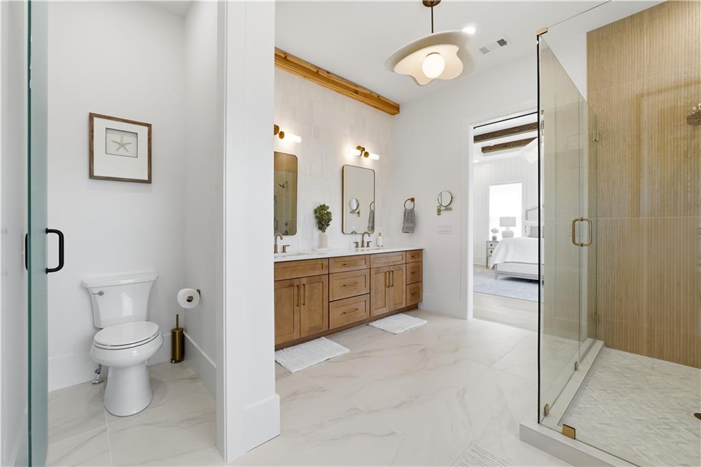 237 Lask Lane Milton, GA 30004 - Photo 41 of 63 a spacious bathroom with a double vanity sink a mirror and a toilet