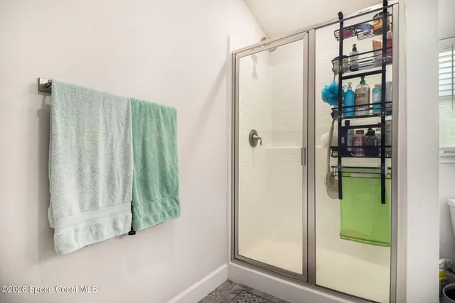 a view of entryway with bathtub and shower