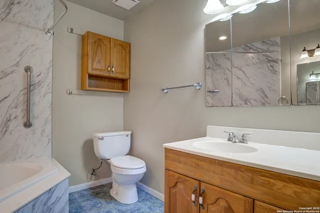 a bathroom with a toilet sink and mirror