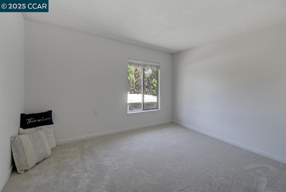 1333 Singingwood Court, Unit 1 Walnut Creek, CA 94595 - Photo 14 of 34 an empty room with a window