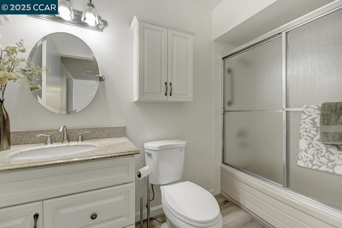1333 Singingwood Court, Unit 1 Walnut Creek, CA 94595 - Photo 19 of 34 a bathroom with a sink a toilet and shower