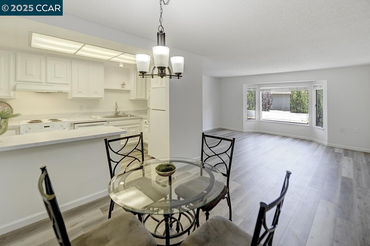 1333 Singingwood Court, Unit 1 Walnut Creek, CA 94595 - Photo 9 of 34 a view of a dining room with furniture and wooden floor