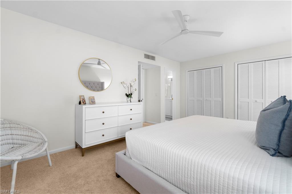 290 4th Street South, Unit 202 Naples, FL 34102 - Photo 11 of 21 a bedroom with a bed and a dresser