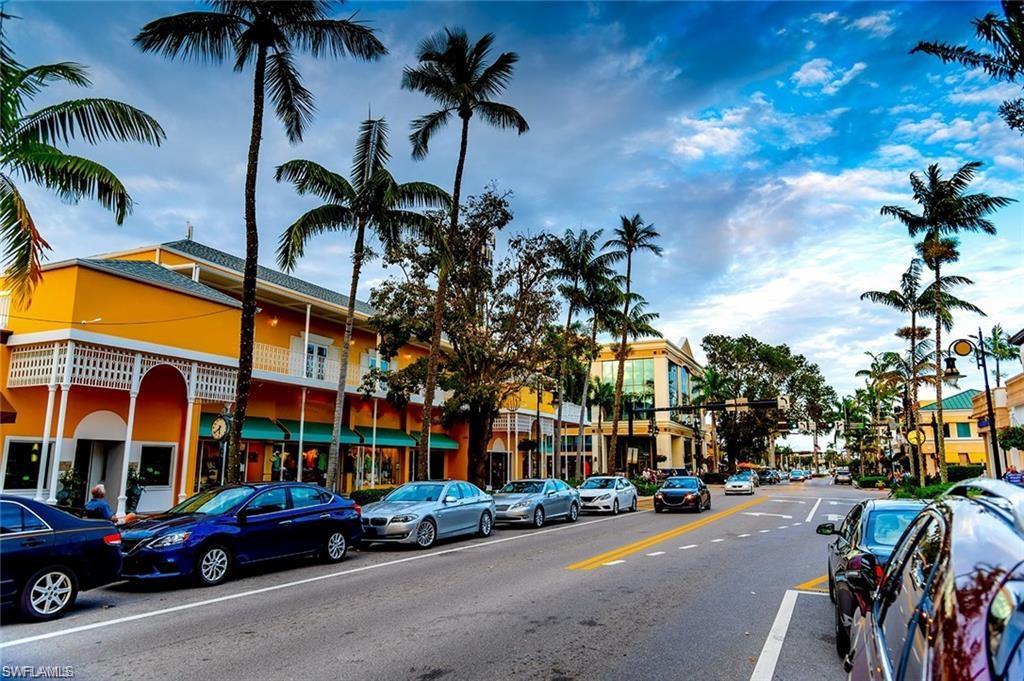 290 4th Street South, Unit 202 Naples, FL 34102 - Photo 17 of 21 a city street lined with buildings and cars