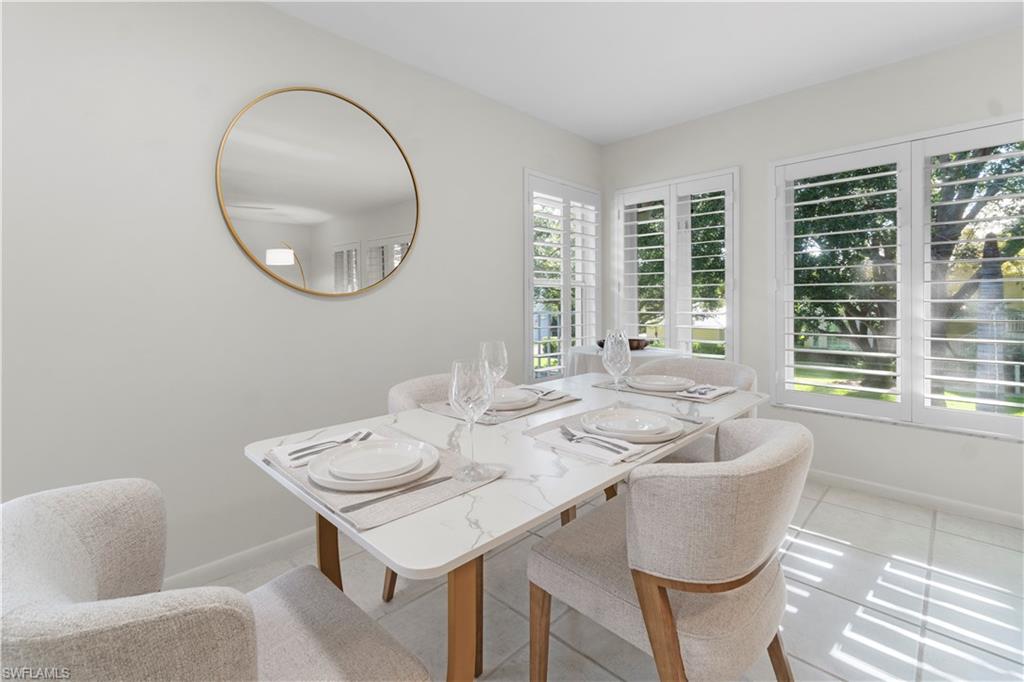290 4th Street South, Unit 202 Naples, FL 34102 - Photo 8 of 21 a view of a dining room with furniture and a large window
