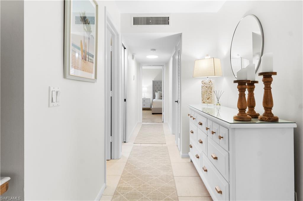 290 4th Street South, Unit 202 Naples, FL 34102 - Photo 9 of 21 a view of a mirror light fixtures and entryway