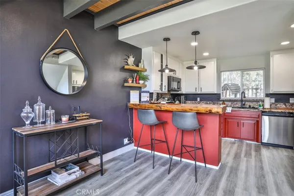 a kitchen with granite countertop a sink stove and cabinets