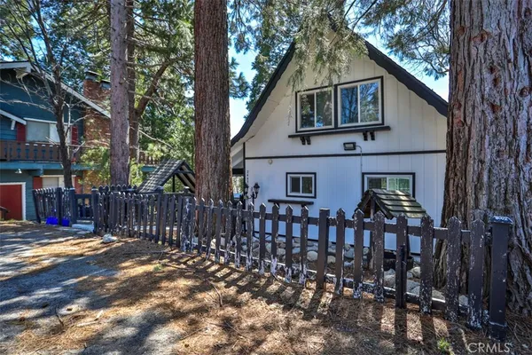 a front view of house with yard outdoor seating and pathway