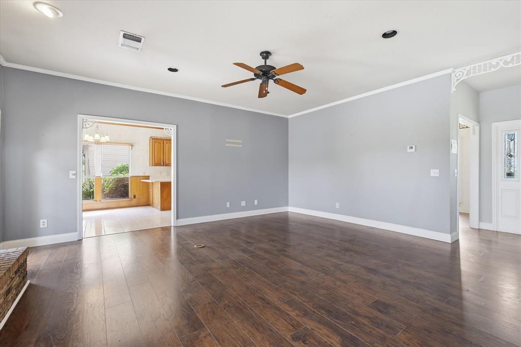 211 Bayne Road Haslet, TX 76052 - Photo 8 of 29 a view of an empty room with window and wooden floor