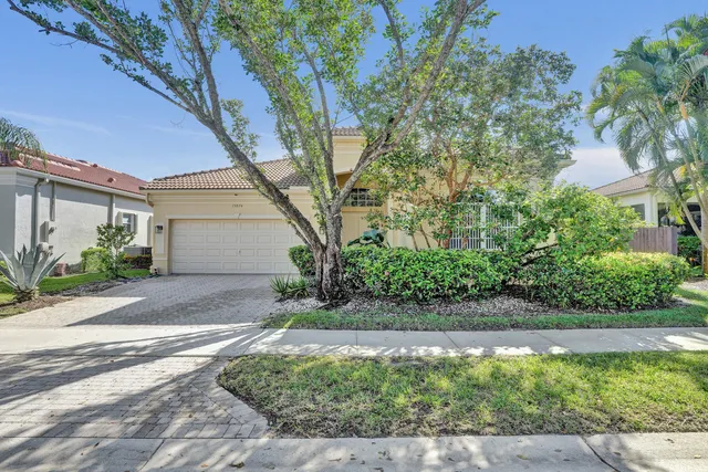 a front view of a house with a yard and a garage