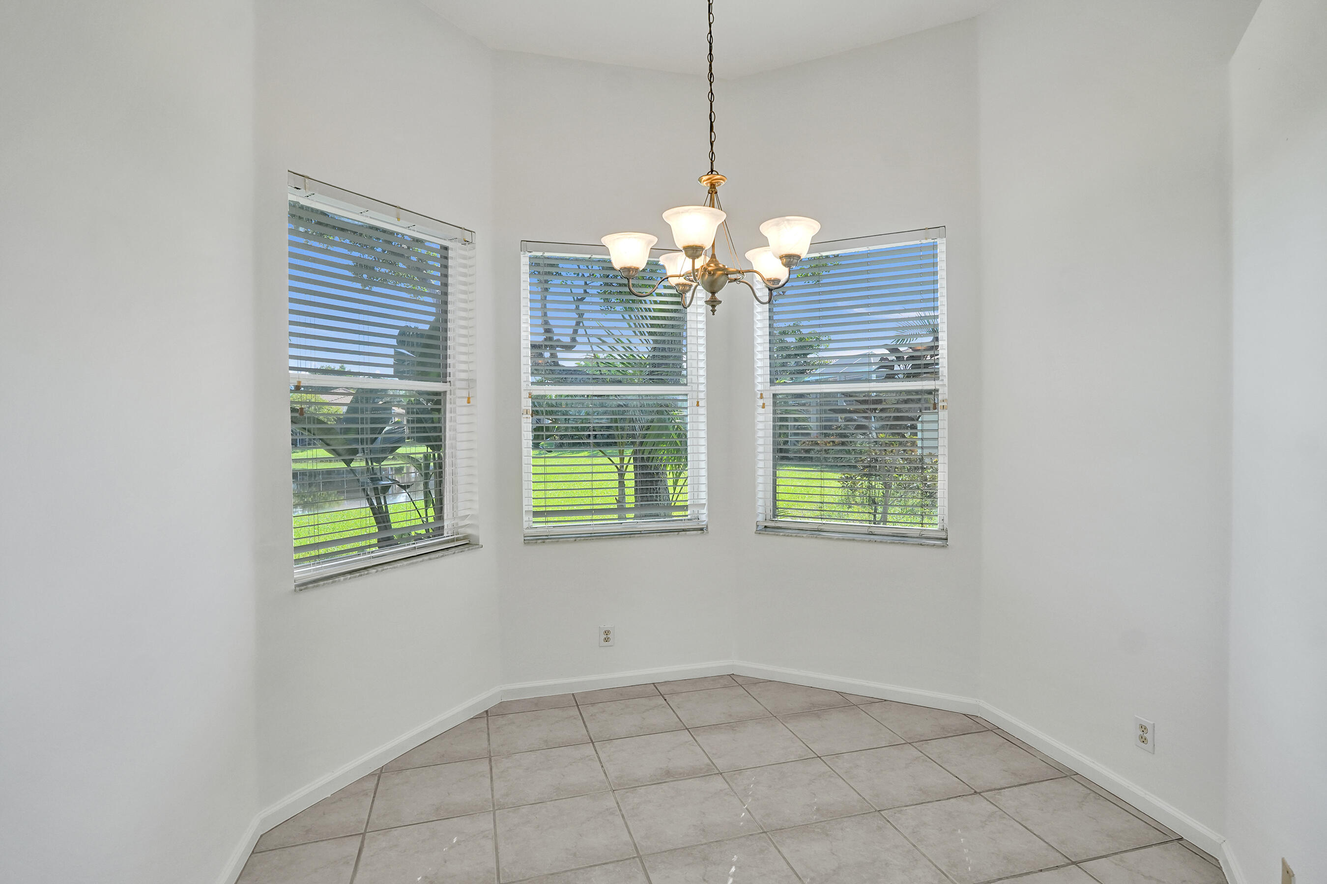 15874 Vivanco Street Delray Beach, FL 33446 - Photo 17 of 33 a view of a room with a window and chandelier