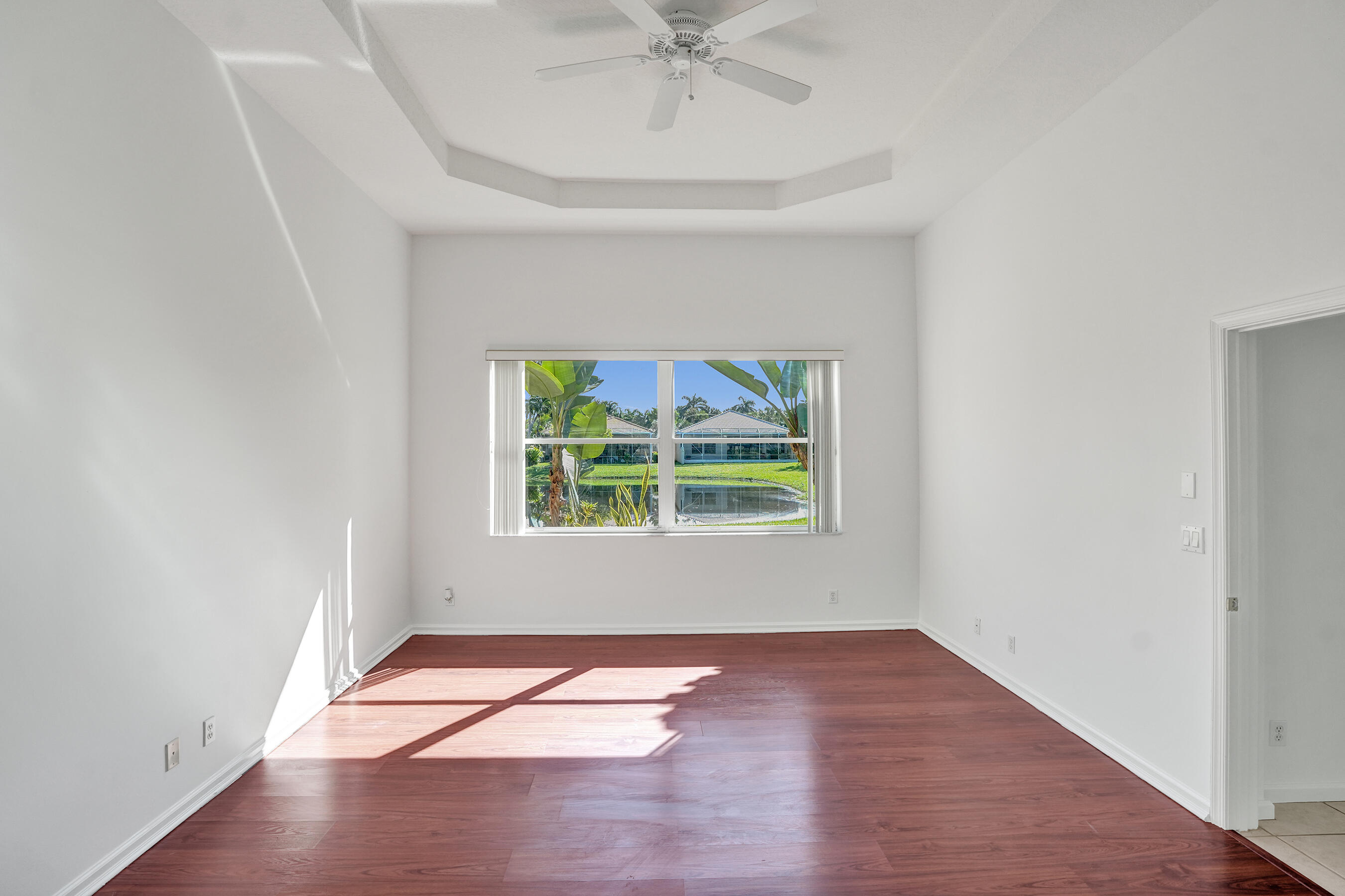 15874 Vivanco Street Delray Beach, FL 33446 - Photo 20 of 33 an empty room with wooden floor and windows