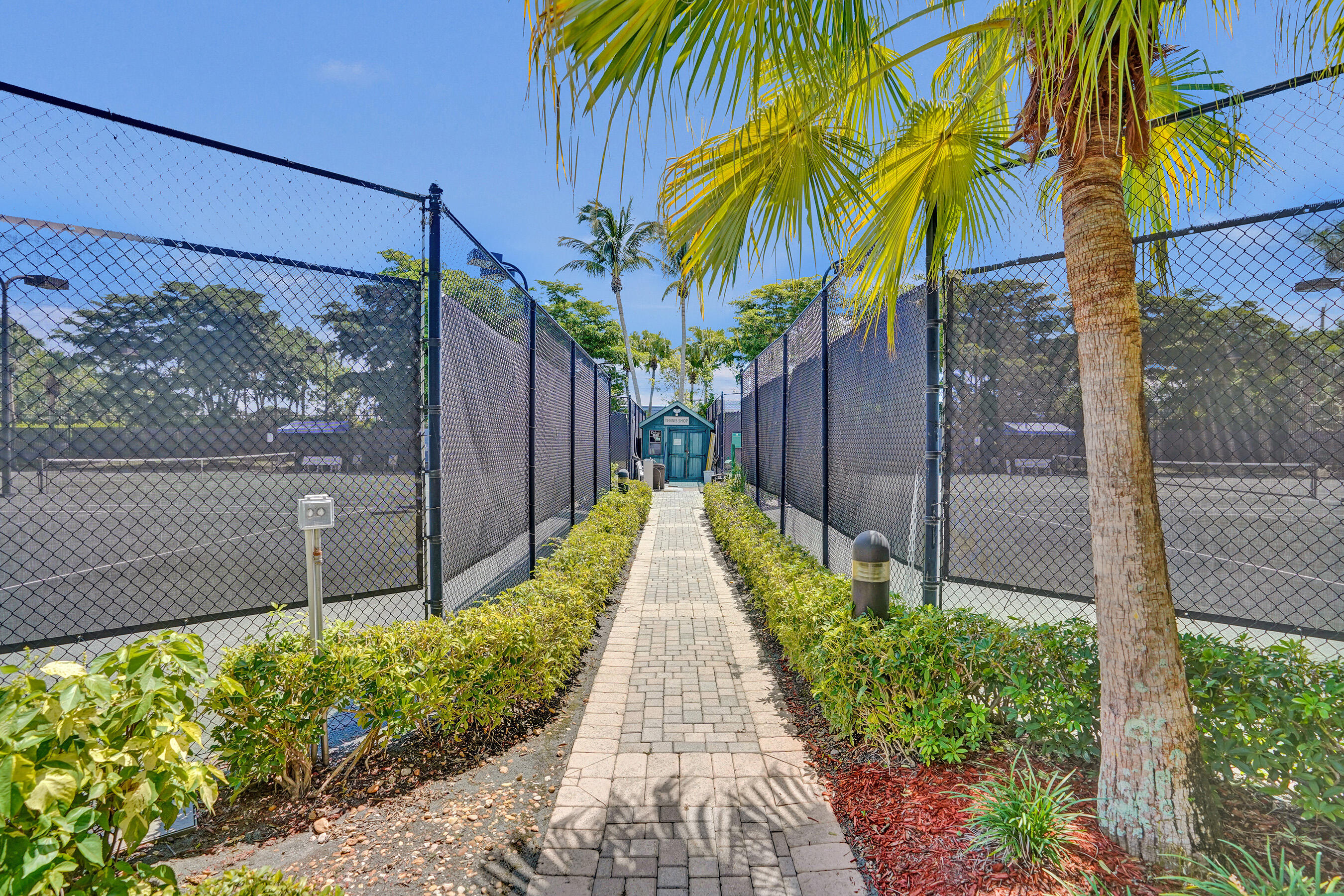 15874 Vivanco Street Delray Beach, FL 33446 - Photo 32 of 33 a view of a pathway with a small yard and a wooden fence