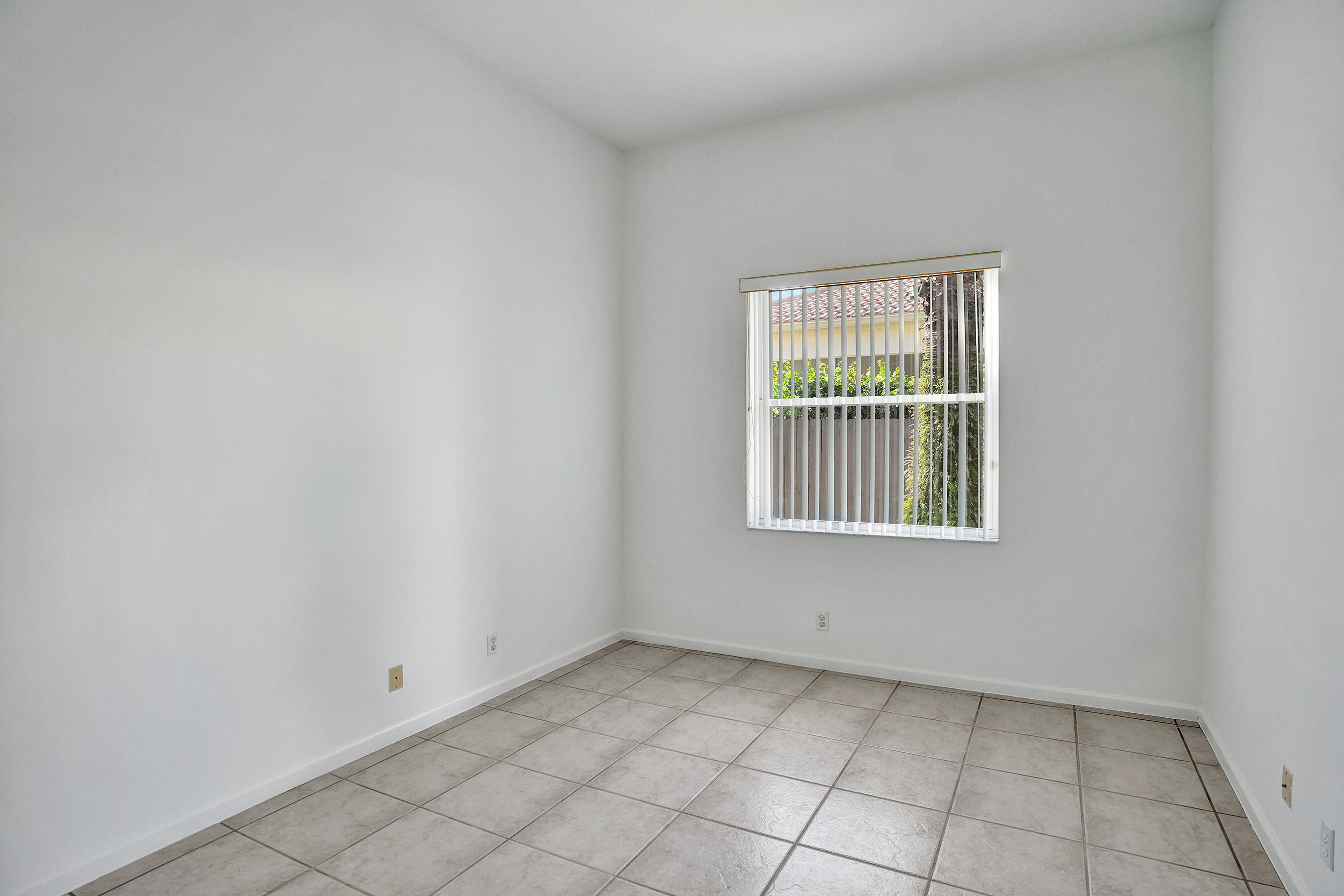 15874 Vivanco Street Delray Beach, FL 33446 - Photo 7 of 33 an empty room with windows