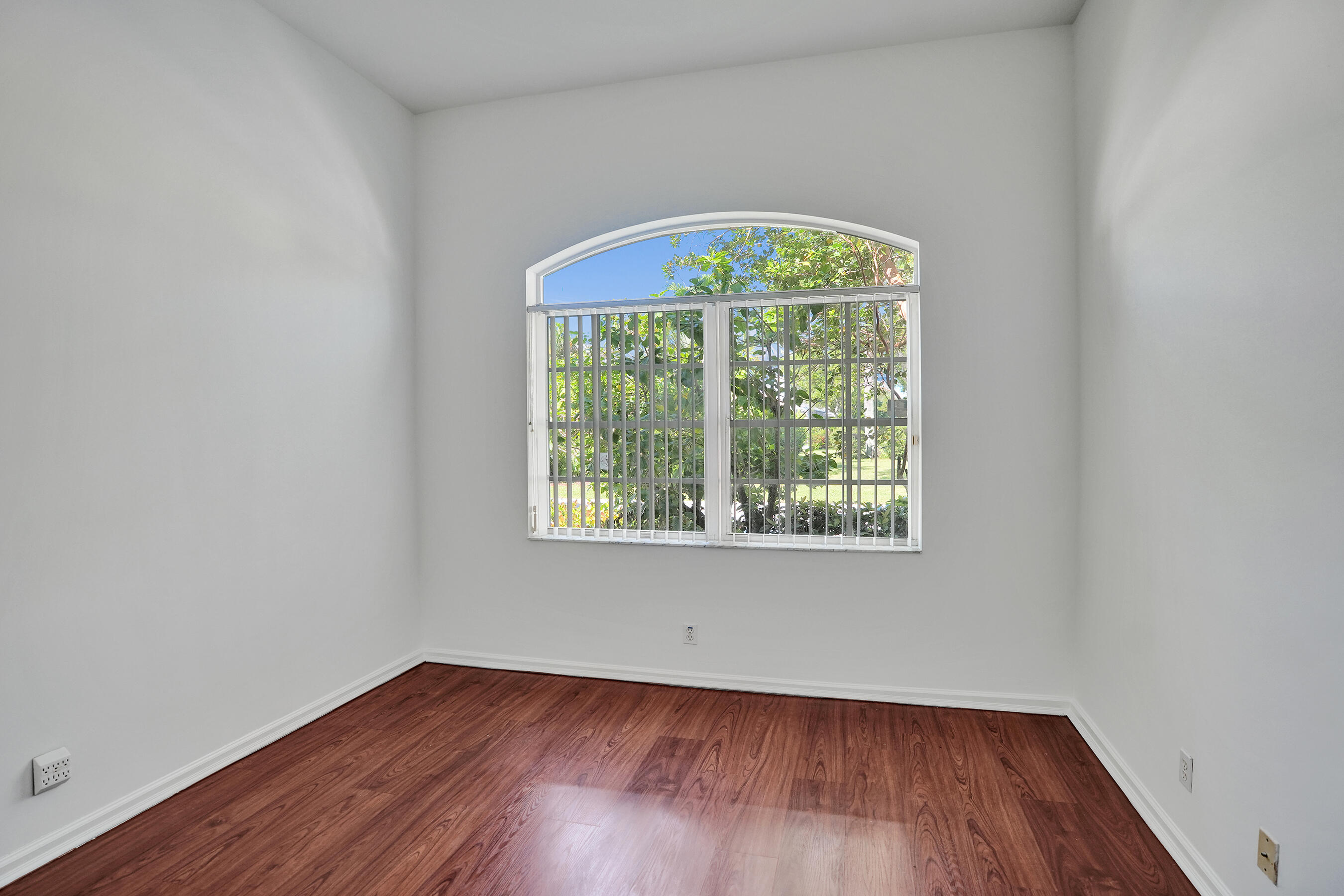15874 Vivanco Street Delray Beach, FL 33446 - Photo 8 of 33 an empty room with wooden floor and a window