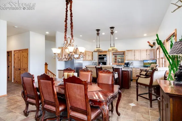 a view of a dining room with furniture large windows and wooden floor