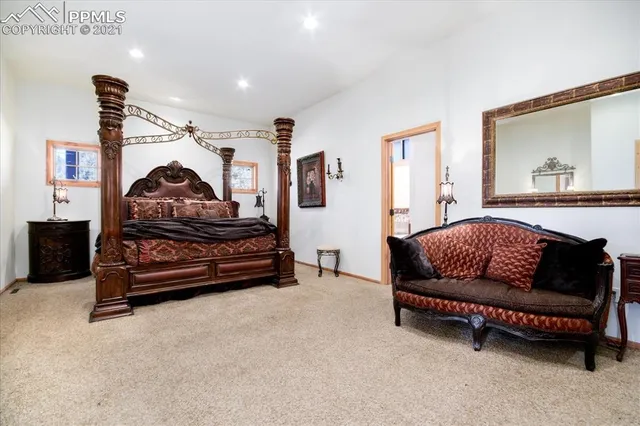 a bedroom with bed and a chandelier