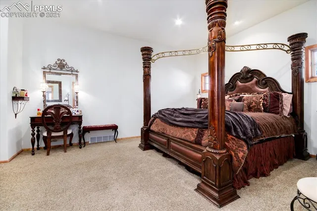 a bedroom with furniture and a large window