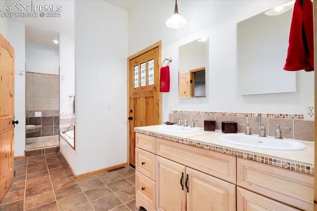 a bathroom with a bathtub and mirror