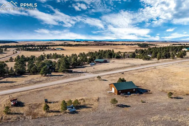 a view of a water with boats and trees in the background