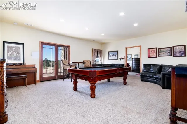 a living room with furniture and large windows