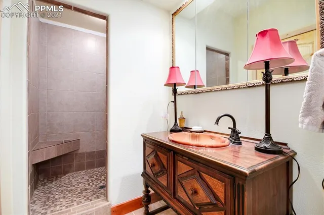 a bedroom with a bed a table and chair