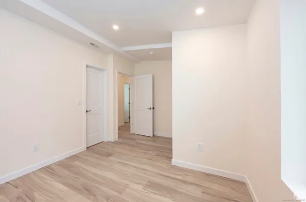 a view of hallway with wooden floor