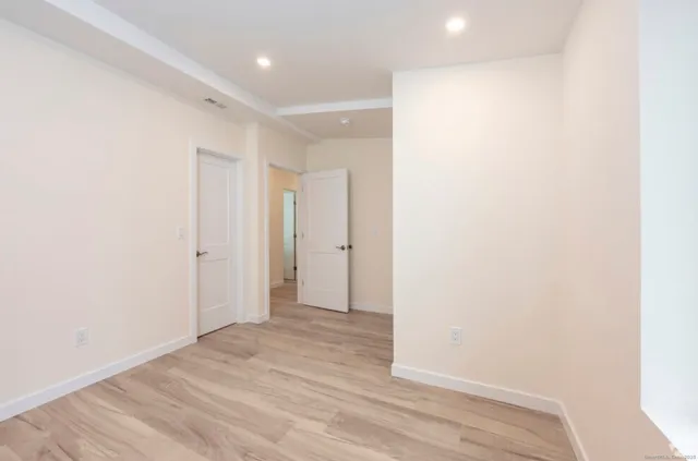a view of hallway with wooden floor