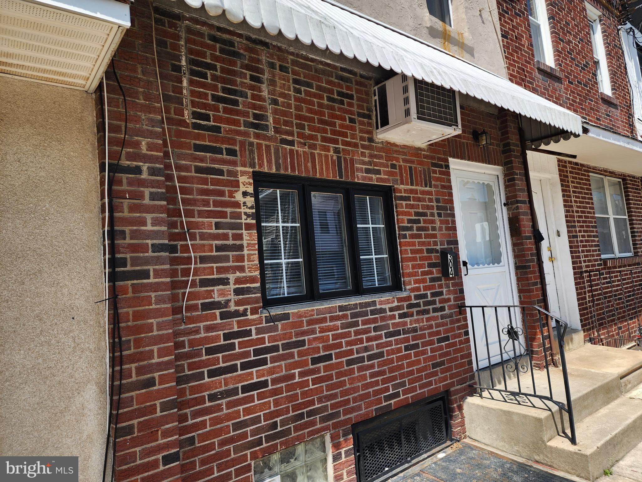 304 North 64th Street Philadelphia, PA 19139 - Photo 3 of 36 a front view of a building with glass windows