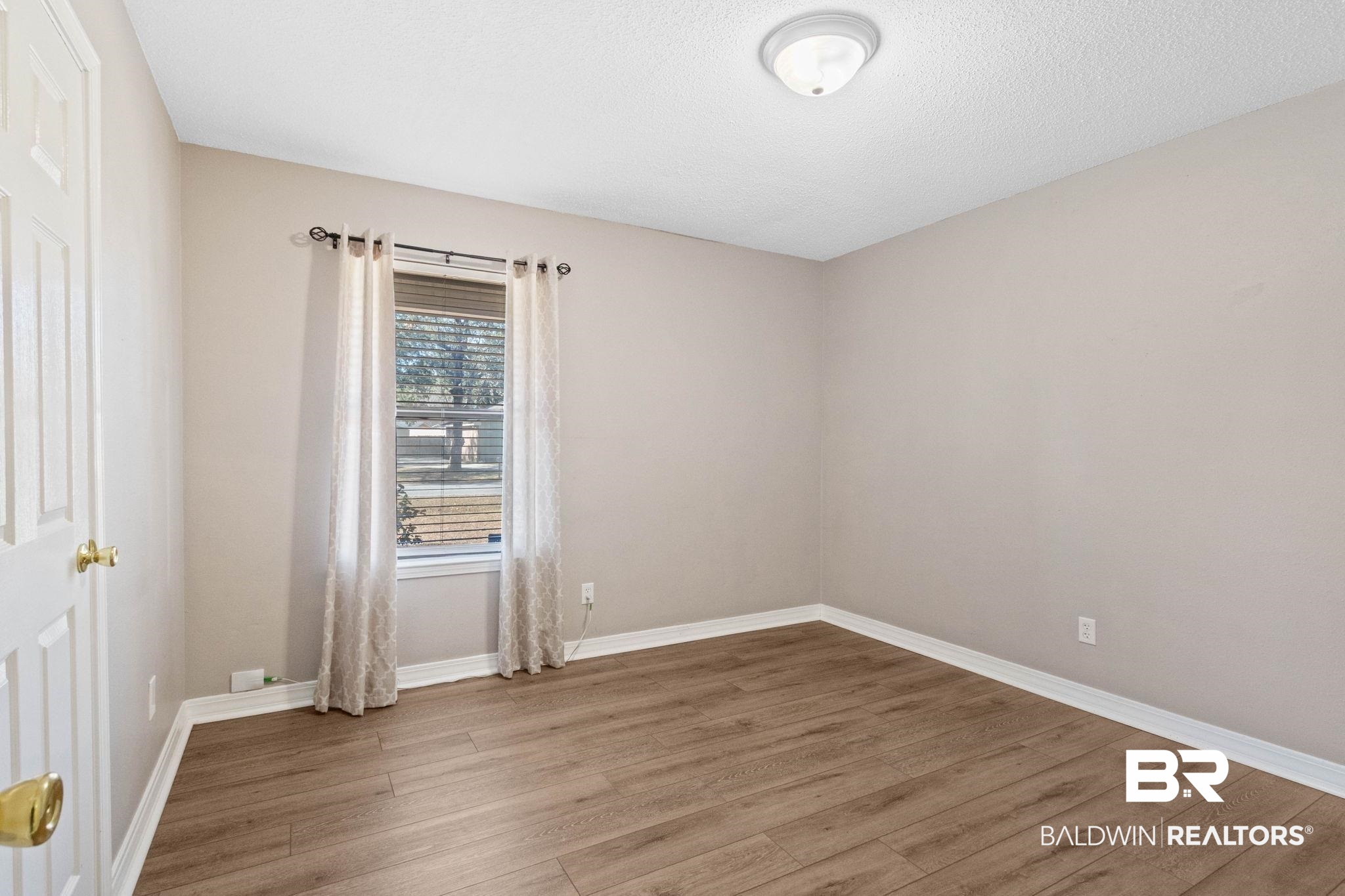 5366 Scanlan Way West Satsuma, AL 36572 - Photo 21 of 43 Empty room with light wood finished floors and baseboards