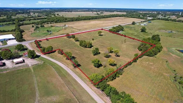 an aerial view of a residential houses with outdoor space