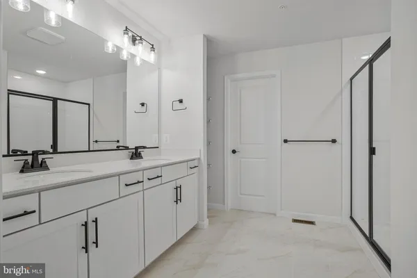 a view of a sink and a mirror in a room