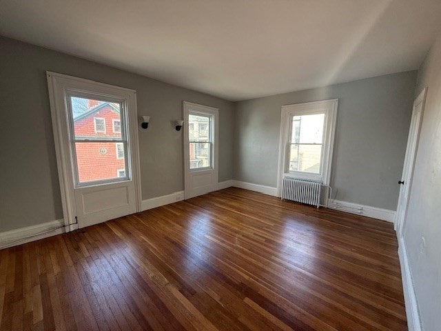 199 Purchase Street, Unit 2 Fall River, MA 02720 - Photo 3 of 9 a view of empty room with window and wooden floor
