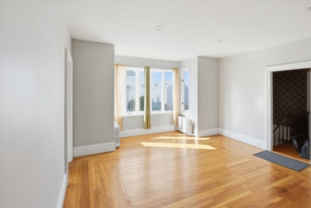 199 Purchase Street, Unit 2 Fall River, MA 02720 - Photo 4 of 10 a view of an empty room with window and a kitchen