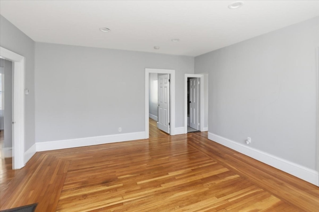 199 Purchase Street, Unit 2 Fall River, MA 02720 - Photo 7 of 10 a view of an empty room and wooden floor